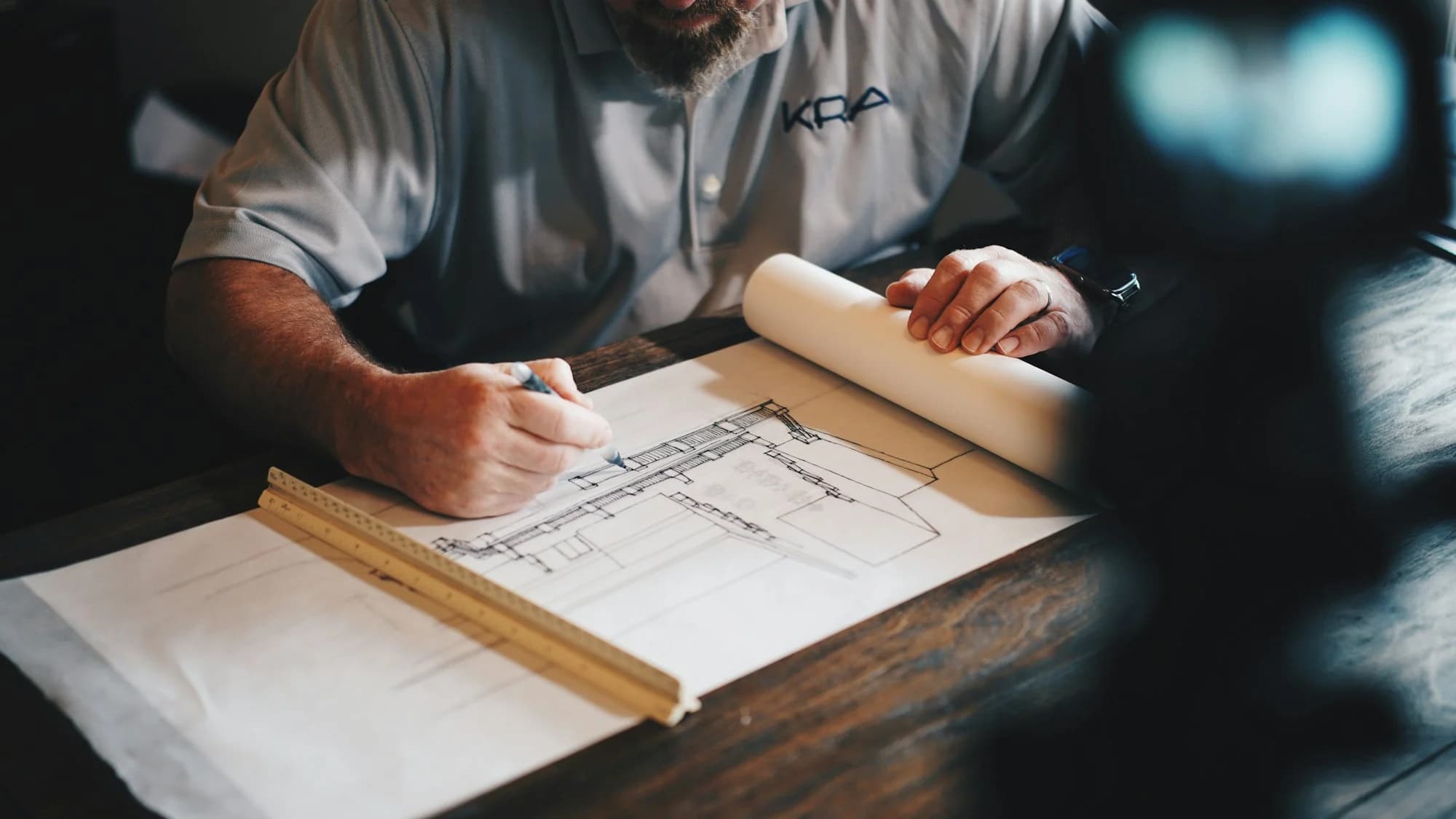 Architect reviewing plans at a desk